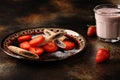 Delicious sweet dessert made from fresh strawberries with chocolate tubes and powdered sugar, Royalty Free Stock Photo