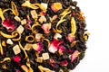 Delicious sweet dried tea close-up. Flavored tea with candied fruit slices, petals, hibiscus, rose