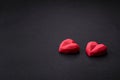 Delicious sweet heart shaped chocolate candies on a dark concrete background