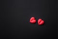 Delicious sweet heart shaped chocolate candies on a dark concrete background