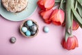 Delicious sweet homemade easter cake, tulips and eggs, top view Royalty Free Stock Photo