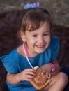 Delicious sweet pastries in children `s hands. A sacky little girl holds a sweet bun in her hands Royalty Free Stock Photo