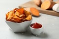 Delicious sweet potato chips in bowl and sauce Royalty Free Stock Photo