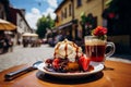 Delicious sweet viennese waffles with berries and syrup on table of an outdoor cafe Royalty Free Stock Photo