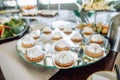 Delicious sweet white cakes on a mirror tray in a restaurant. Food for dessert Royalty Free Stock Photo