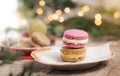 Delicious sweets on plate, macaroons on wooden table