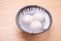 Delicious tang yuan, yuanxiao in a small bowl. Traditional festive food rice dumplings ball with stuffed fillings for Chinese