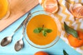 Delicious tangerine jelly and fresh fruits on light blue wooden table, flat lay Royalty Free Stock Photo