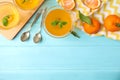 Delicious tangerine jelly and fresh fruits on light blue wooden table, flat lay. Space for text Royalty Free Stock Photo