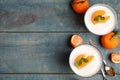 Delicious tangerine jelly and fresh fruits on light blue wooden table, flat lay. Space for text Royalty Free Stock Photo