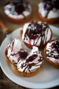 Delicious tartlets with cream cheese, chocolate and cherries. Royalty Free Stock Photo