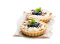 Delicious tarts with cream and fresh blueberry isolated on whit