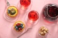 Delicious tarts with fruits and cups of tea on color table