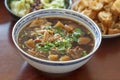 Delicious and tasty Bah Kut Teh pork rib soup served with stir ice salad and fried onion plus fired bread. This a typical