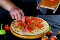 Raw pizza with tomatoes, cheese and sausage salami Royalty Free Stock Photo