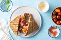 Delicious and tasty sandwich with salmon, basil, cherry tomatoes and caper. Close up selective focus. Traditional Royalty Free Stock Photo