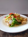 Delicious and tasty stir-fry cabbage with tofu on a white plate