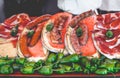 Delicious tasty street food at a market in Spain. Fried meat sausages, toast with tomato and Iberian ham. Royalty Free Stock Photo