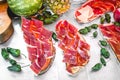 Delicious tasty street food at a market in Spain. Iberian ham toast with tomato