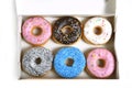 Delicious and tempting box full of donuts with different flavours and toppings sugar addiction concept