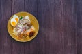 Delicious Thai food. Noodle with hot and sour seafood prawn and squid soup with slice boiled egg and vegetable in brown bowl at Royalty Free Stock Photo