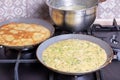 Delicious thin pancake in frying pan on stove