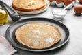 Delicious thin pancake on grey marble table