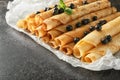 Delicious thin pancakes with currant on dark table Royalty Free Stock Photo