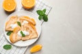 Delicious thin pancakes with oranges and cream on marble table, flat lay. Space for text