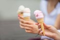 Delicious three ice cream in female hands - close-up