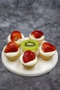 Delicious tiny tartlets tarts, open pastry pies on a dark background. Royalty Free Stock Photo