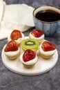 Delicious tiny tartlets tarts, open pastry pies on a dark background. Royalty Free Stock Photo