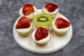 Delicious tiny tartlets tarts, open pastry pies on a dark background. Royalty Free Stock Photo