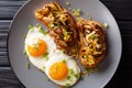 Delicious toast with shiitake mushrooms and cheddar cheese served with fried eggs close-up on a plate. horizontal top view Royalty Free Stock Photo