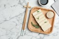 Delicious tofu with rosemary served on white marble table, flat lay. Space for text Royalty Free Stock Photo