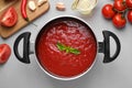 Delicious tomato sauce on light grey table