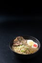 Delicious tonkotsu ramen, Japanese noodle in pork Bone based soup topped with chashu pork, boiled egg, pickled bamboo shoot