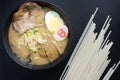 Delicious tonkotsu ramen, Japanese noodle in pork Bone based soup topped with chashu pork, boiled egg, pickled bamboo shoot