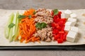 Delicious tortilla with tuna and vegetables on grey table, closeup. Cooking shawarma