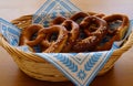 Delicious traditional Bavarian pretzels with brown salty crust on traditional Bavarian cocktail napkin in basket