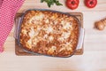 Delicious traditional italian lasagna made with minced beef bolognese sauce on wooden table Royalty Free Stock Photo