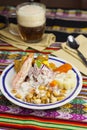 Delicious traditional Peruvian ceviche plated with beer. Royalty Free Stock Photo