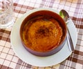Delicious traditional Spanish dessert - Crema catalana served with spoon in clay bowl Royalty Free Stock Photo