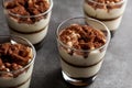 Delicious traditional tiramisu desert served in small glass cups on stone countertop. Royalty Free Stock Photo