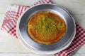 Delicious traditional Turkish kunefe with pistachio on it. Served hot and with syrup