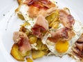 Delicious traditional Tyrolean mountain dish with cut grilled potatoes, speck and eggs. View from the top