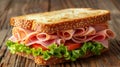 Delicious triangle sandwich with ham, cheese, tomato, and fresh salad ingredients Royalty Free Stock Photo