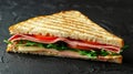 Delicious triangle sandwich with ham, cheese, tomato, and fresh salad ingredients Royalty Free Stock Photo