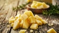 Delicious triangular cheese chunks artfully arranged on a rustic wooden table surface