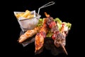 Delicious triple skewers and fried potatoes with reflection